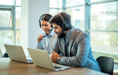 Support specialist wearing a headset at a laptop